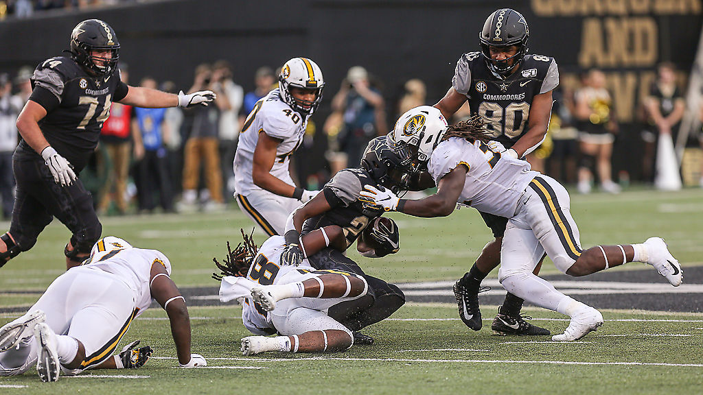 Vanderbilt freshman running back Keyon Brooks is tackled by Missouri linebackers Jatorian Hansford and Nick Bolton
